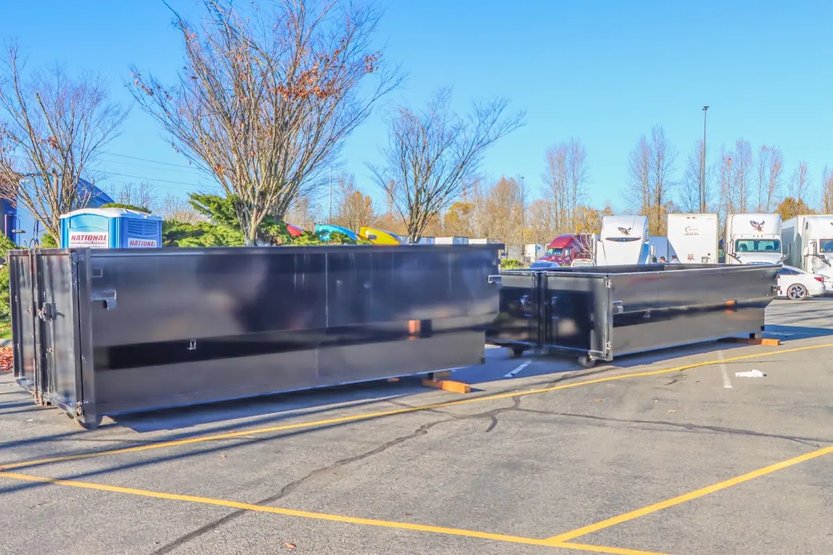 Professional dumpster rental service with roll-off container on residential driveway in San Jacinto